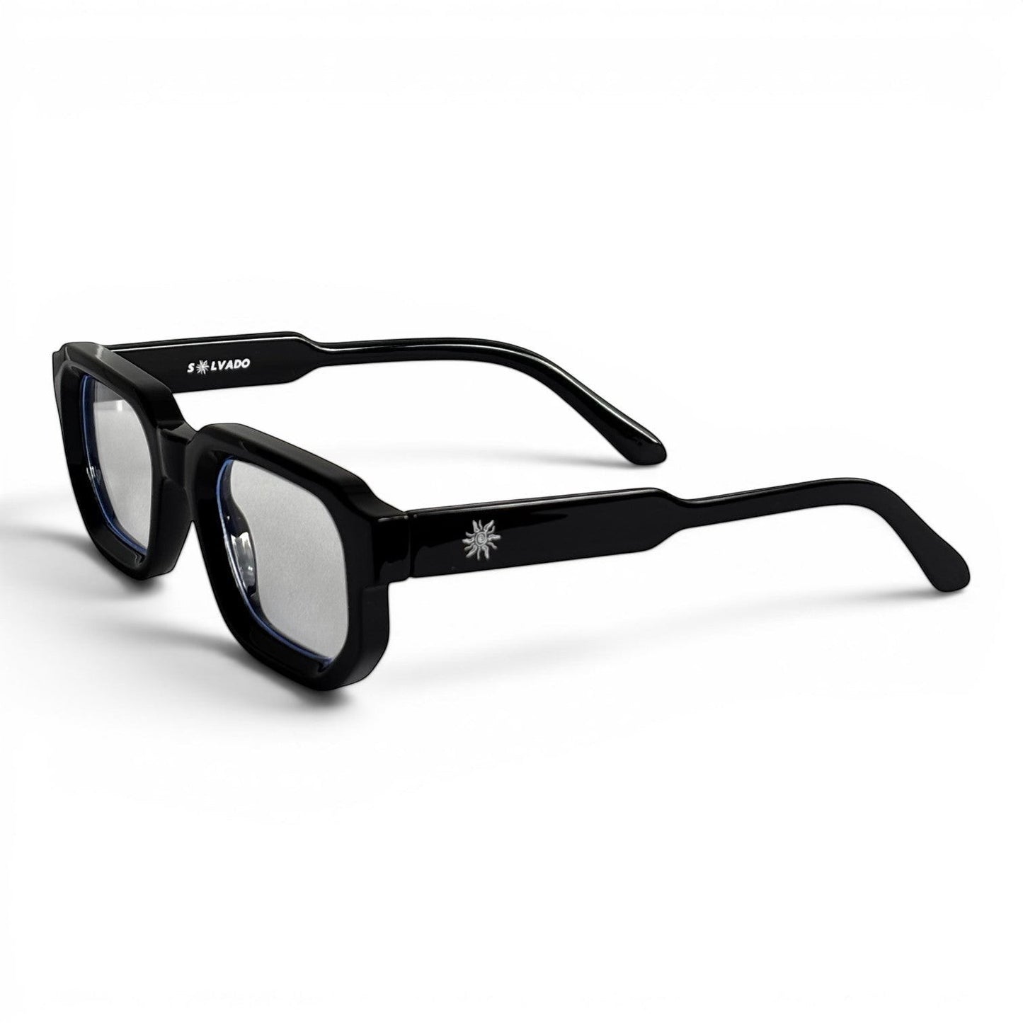 solvado Midnight Clear Brille mit glänzend schwarzem Acetatrahmen in quadratischer Form und goldenem Sonnen-Emblem.