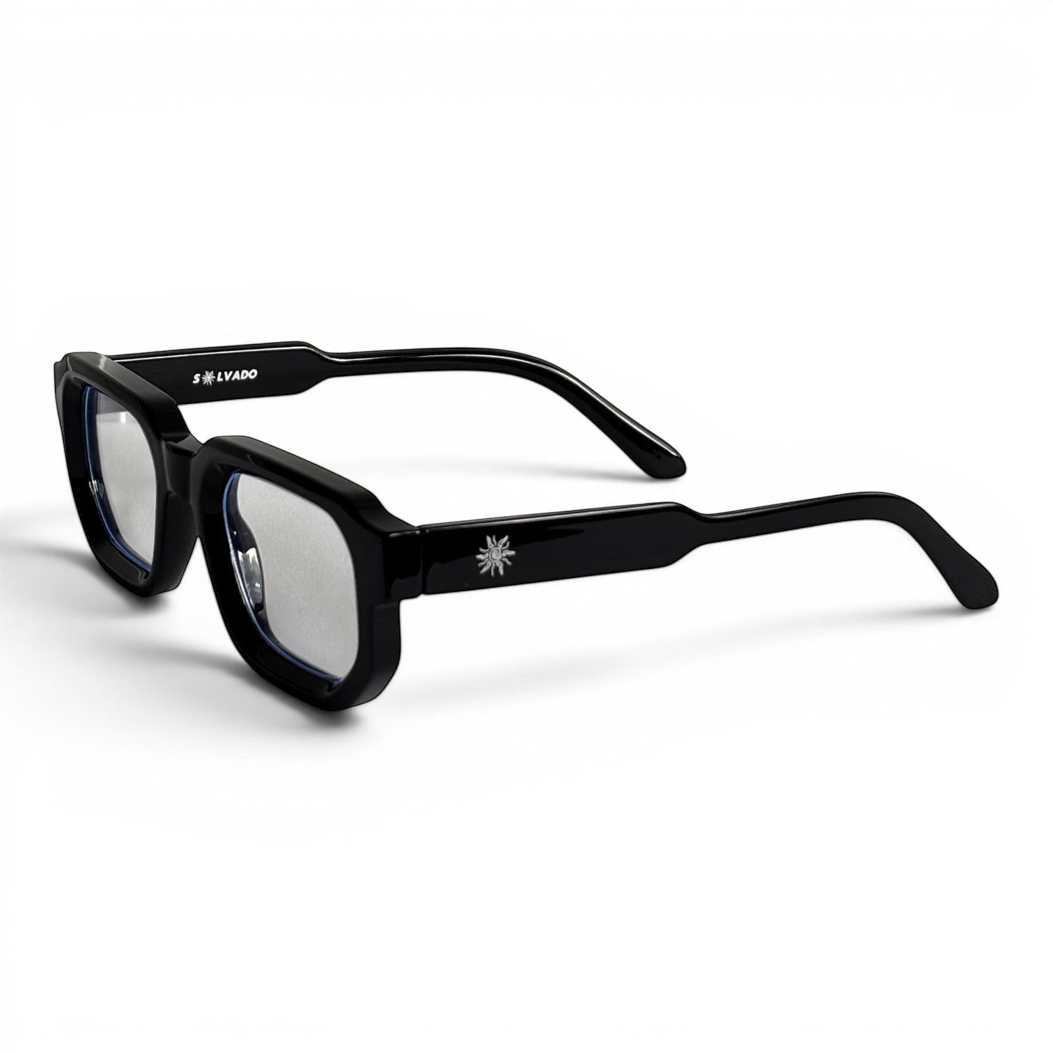 solvado Midnight Clear Brille mit glänzend schwarzem Acetatrahmen in quadratischer Form und goldenem Sonnen-Emblem.